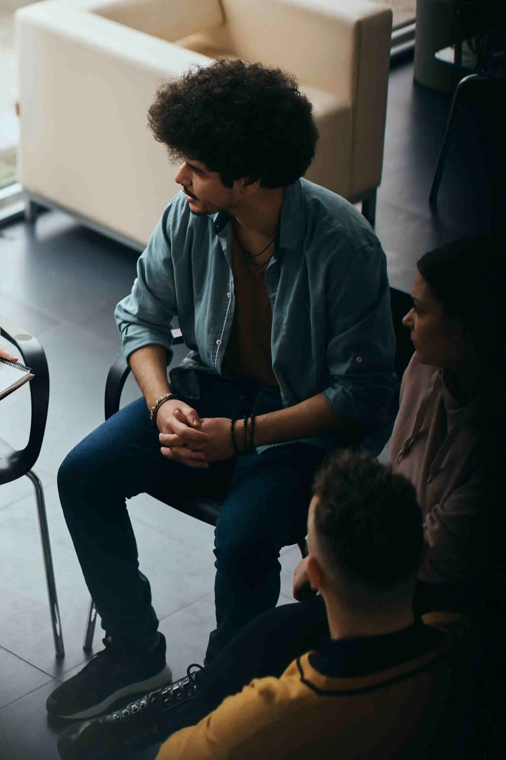 Therapist leading a group therapy session with several participants
