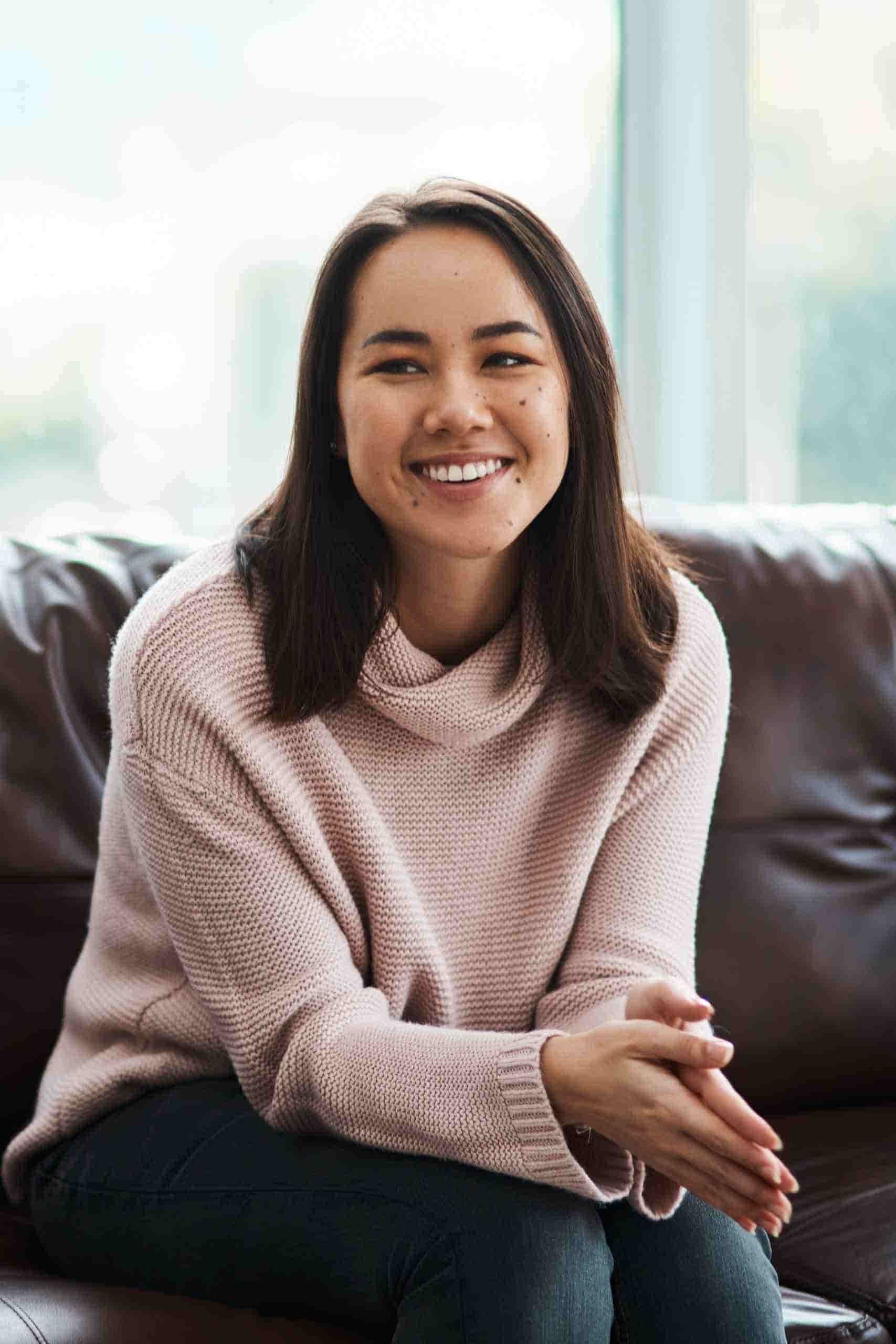 Woman smiling while speaking with a therapist during an individual therapy session