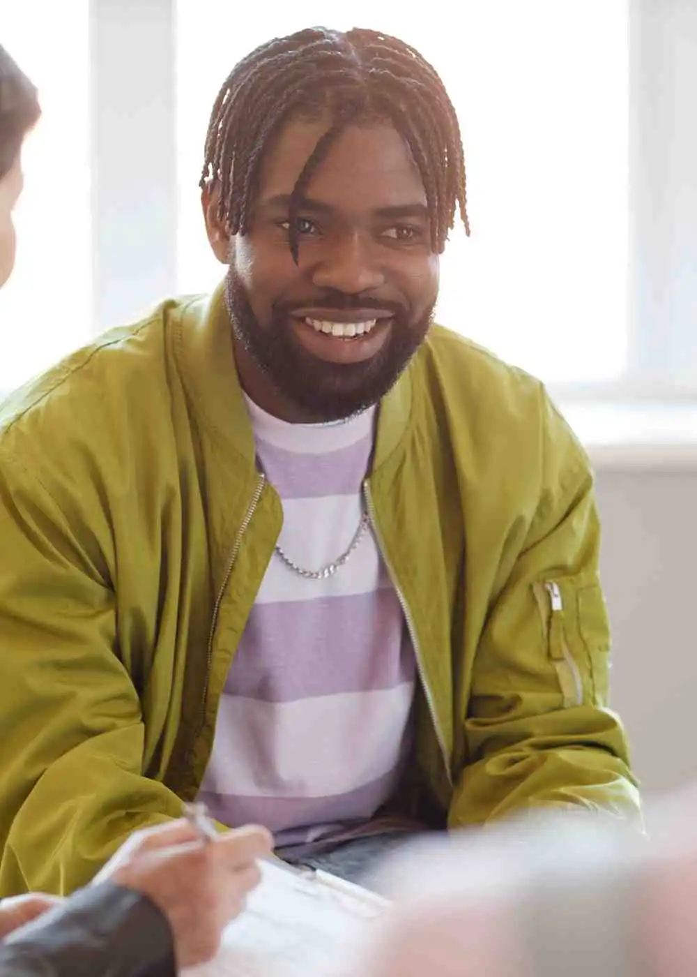 Man smiling during a counseling session in inpatient addiction treatment