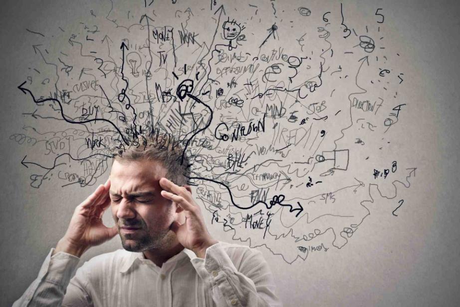 Man holding his head with chaotic thoughts illustrating how addiction affects brain function and mental clarity